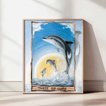 Load image into Gallery viewer, This art print features the Three of Cups tarot card from the Animism Tarot: three dusky dolphins jump out of the ocean, enjoying the warmth of the sun together.
