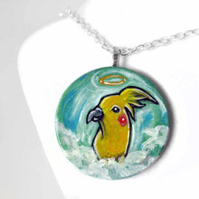 Load image into Gallery viewer, art of a yellow cockatiel as an angel in the clouds, painted on a small wood disc, available as a keepsake or necklace
