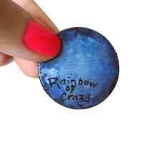 Load image into Gallery viewer, The back of the wood pendant of a black cat, signed with "Rainbow of Crazy"
