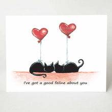 Load image into Gallery viewer, a greeting card with two black cats curled up next to each other, each having a heart shaped balloon tied to them. The card reads, "I've got a good feline about you"
