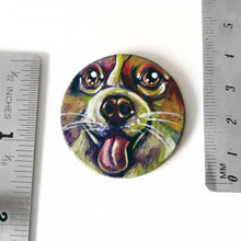 Load image into Gallery viewer, A circle wood disc with a portrait of a corgi, hand painted in rainbow colours, next to two rulers to show its size: 1 1/2" or 3.8 cm across
