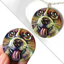 Load image into Gallery viewer, A circle wood pendant featuring a portrait of a corgi in all the colours of the rainbow. Available as either a keepsake, fridge magnet, or a necklace
