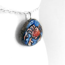 Load image into Gallery viewer, a stone necklace, hand painted with a crab, the zodiac sign of cancer, surrounded by blue water
