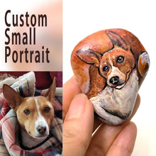Load image into Gallery viewer, a small beach rock custom painted with a portrait of a Basenji dog
