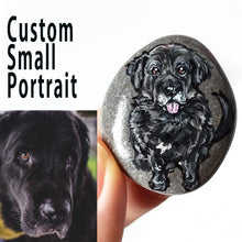 Load image into Gallery viewer, a small beach pebble painted with art of a black dog

