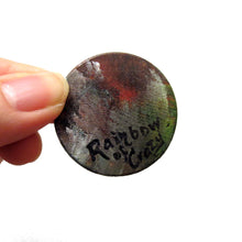 Load image into Gallery viewer, The back of a dacshund wood pendant, signed with "Rainbow of Crazy"
