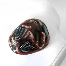 Load image into Gallery viewer, the back side of a beach stone, hand painted with the portrait of a walrus, showing its flippers and signed with "Rainbow of Crazy"
