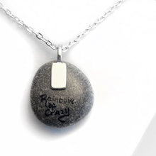 Load image into Gallery viewer, The back of the White Cat Portrait Necklace, signed with "rainbow of crazy"
