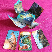 Load image into Gallery viewer, The Animism Tarot Mini Borderless Edition, deck and box. Displayed are the Three of Wands, The World, and The Emperor
