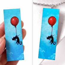 Load image into Gallery viewer, a wood rectangle hand painted with art of a black cat, with a red balloon, floating through a blue sky. available as a keepsake or pendant necklace
