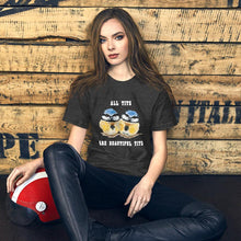 Load image into Gallery viewer, A woman wearing the Beautiful Tits Premium Unisex T-shirt in dark grey heather, with art of two blue tit birds, and the words, "all tits are beautiful tits"
