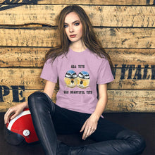 Load image into Gallery viewer, A woman wearing the Beautiful Tits Premium Unisex T-shirt in heather prism lilac, with art of two blue tit birds, and the words, "all tits are beautiful tits"
