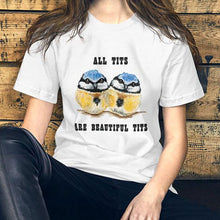 Load image into Gallery viewer, A woman wearing the Beautiful Tits Premium Unisex T-shirt in white with art of two blue tit birds, and the words, "all tits are beautiful tits"
