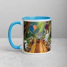 Load image into Gallery viewer, An 11 oz ceramic coffee mug, with blue trim, printed with art of a cupcake party with three rabbits, two hamsters and a chinchilla in the forest
