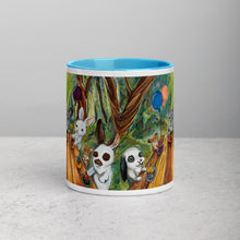 Load image into Gallery viewer, An 11 oz ceramic coffee mug, with blue trim, printed with art of a cupcake party with three rabbits, two hamsters and a chinchilla in the forest
