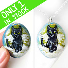 Load image into Gallery viewer, Rock art of a black cat as an angel, painted on a small beach stone, it's available alone, fridge magnet, or as a pendant necklace.
