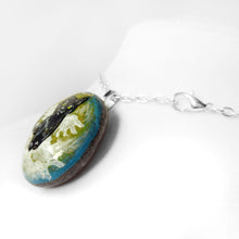 Load image into Gallery viewer, Rock art of a black cat as an angel, painted on a small beach stone, it's available alone, fridge magnet, or as a pendant necklace.

