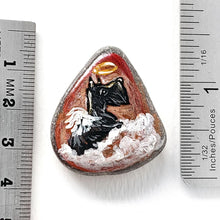 Load image into Gallery viewer, Rock art of a Scottish Terrier as an angel, painted on a small beach stone, next to rulers to show its size: 1 3/8" x  1 1/4" or 3.5 cm x 3.1 cm
