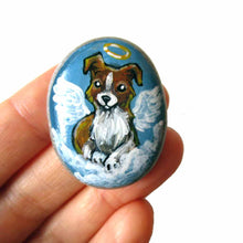 Load image into Gallery viewer, Small rock art of a border collie, painted as an angel, with halo and wings, sitting on clouds. available as a keepsake or pendant necklace

