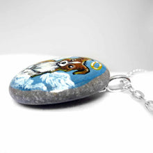 Load image into Gallery viewer, Small rock art of a border collie, painted as an angel, with halo and wings, sitting on clouds. available as a keepsake or pendant necklace
