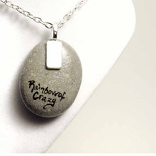Load image into Gallery viewer, Small rock art of a border collie, painted as an angel, with halo and wings, sitting on clouds. available as a keepsake or pendant necklace, back signed with, Rainbow of Crazy
