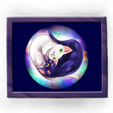 Load image into Gallery viewer, an art print of a white cat with green eyes, and a purple/black cat with red eyes, curled up in a shape of a heart. a galaxy of stars are behind them. tiny crescent moons are on their foreheads.
