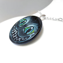 Load image into Gallery viewer, a portrait of an evil looking Cheshire Cat with an evil smile, hand painted on a wood disc. it's available as a keepsake or pendant necklace
