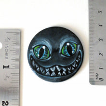 Load image into Gallery viewer, a portrait of an evil looking Cheshire Cat with an evil smile, hand painted on a wood disc. it's available as a keepsake or pendant necklace
