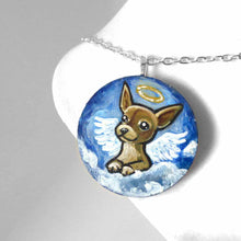 Load image into Gallery viewer, a small lightweight wood circle, hand painted with the portrait of a chihuahua as an angel in the clouds. available as a keepsake or pendant necklace
