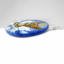 Load image into Gallery viewer, a small lightweight wood circle, hand painted with the portrait of a chihuahua as an angel in the clouds. available as a keepsake or pendant necklace
