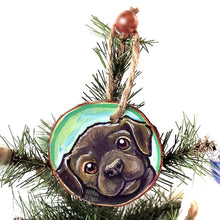 Load image into Gallery viewer, A wood Christmas ornament, hand painted with art of a brown labrador dog with reddish brown eyes
