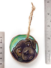 Load image into Gallery viewer, A wood Christmas ornament, hand painted with art of a brown labrador dog with reddish brown eyes

