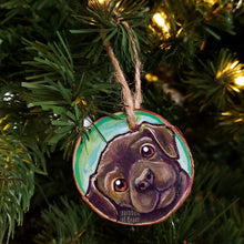 Load image into Gallery viewer, A wood Christmas ornament, hand painted with art of a brown labrador dog with reddish brown eyes
