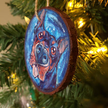 Load image into Gallery viewer, A Christmas wood ornament, featuring art of a doberman with a big blop of the tongue.

