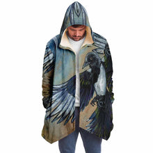 Load image into Gallery viewer, a man wearing a navy blue and orange cloak, featuring art from the Eight of Cups card, from the Animism Tarot: a magpie, with wings spread, flies up into the night sky.
