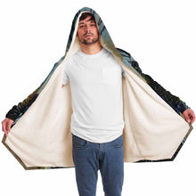 Load image into Gallery viewer, a man wearing a navy blue and orange cloak, featuring art from the Eight of Cups card, from the Animism Tarot: a magpie, with wings spread, flies up into the night sky.
