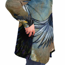 Load image into Gallery viewer, a man wearing a navy blue and orange cloak, featuring art from the Eight of Cups card, from the Animism Tarot: a magpie, with wings spread, flies up into the night sky.
