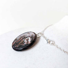 Load image into Gallery viewer, a ferret sleeping, hand painted on a circle wood disc, available as a keepsake or pendant necklace
