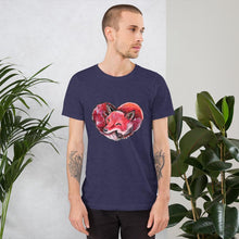 Load image into Gallery viewer, A man is wearing the Fox Love Premium Unisex T-shirt in the colour heather midnight navy, which includes a graphic of a red fox sleeping in the shape of a heart.
