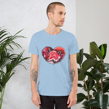 Load image into Gallery viewer, A man is wearing the Fox Love Premium Unisex T-shirt in the colour light blue, which includes a print of a red fox sleeping in the shape of a heart.
