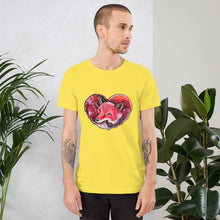 Load image into Gallery viewer, A man is wearing the Fox Love Premium Unisex T-shirt in the colour yellow, which includes a print of a red fox sleeping in the shape of a heart.
