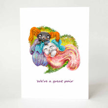 Load image into Gallery viewer, a greeting card featuring art of a black cat and white cat cuddling together in giant socks with smaller socks on their ears. The black cat finishes knitting one of the white cat's socks. the card reads, we're a great pair.
