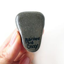 Load image into Gallery viewer, the back of a greyhound portrait stone, signed with, "rainbow of crazy"
