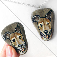Load image into Gallery viewer, a beach rock painted with art of a close-up of a brown greyhound smiling, available as a stone, fridge magnet, or necklace
