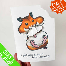 Load image into Gallery viewer, A greeting card featuring art of a Syrian hamster with big, full cheeks, with the text, "I got you a card! ... but I eated it". The top right corner of the card is ripped off and is attached to the hamster's mouth.
