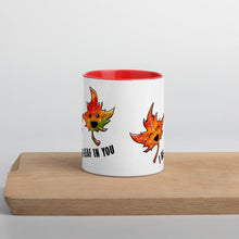 Load image into Gallery viewer, Ah 11 oz white ceramic mug with red handle and interior, printed on the front and back with a graphic of two maple leaves, and the words, "I be-leaf in you"
