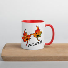 Load image into Gallery viewer, Ah 11 oz white ceramic mug with red handle and interior, printed on the front and back with an image of two maple leaves, and the words, "I be-leaf in you"
