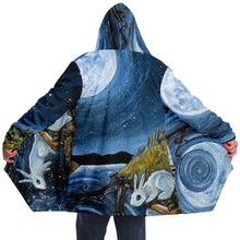 Load image into Gallery viewer, a man wearing the Moon Tarot Cloak, featuring art from the Animism Tarot: a white rabbit looks at the reflection of the moon in the water
