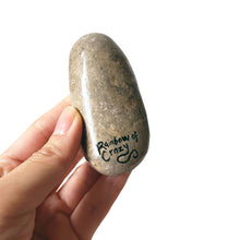 Load image into Gallery viewer, the back of a Newfoundland dog stone, signed with rainbowofcrazy
