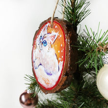 Load image into Gallery viewer, A wooden ornament with a painting of a white Ragamuffin cat with blue eyes, watching the snow fall
